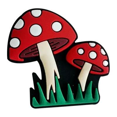 Two red toadstools in grass, soft PVC charm